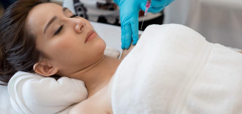 Surgery cosmetology inject botox in breast.